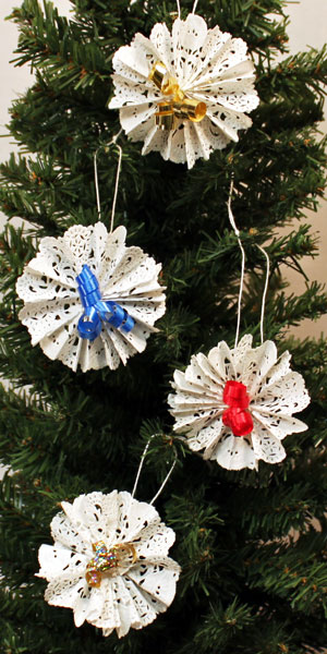 Easy Christmas Crafts Paper Doily Flower Ornament four finished hanging on tree