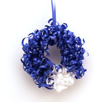 Curly Ribbon Ornament of blue and white ribbon on a white background