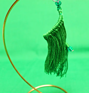 Fringed Yarn Ornament green finished on display