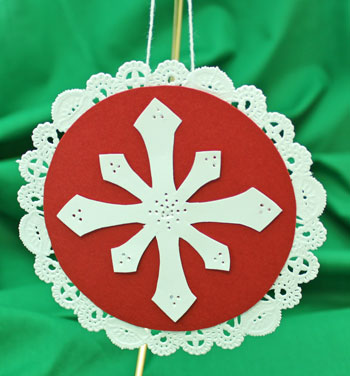Paper Doily Snowflake Ornament hanging on display
