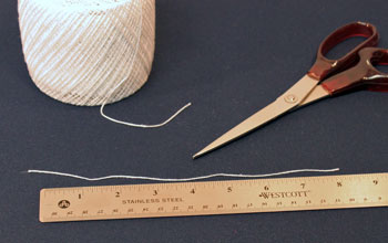 Easy Christmas crafts Button Snowman Ornament Step 3 cut yarn
