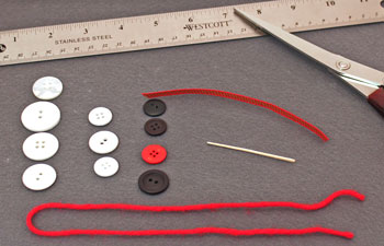 Button and yarn snowman materials and tools
