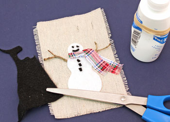 Easy Christmas Crafts Felt and Twig Snowman step 9 glue buttons and face