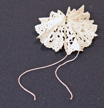Easy Christmas Crafts Paper Doily Flower Ornament step 10 pull yarn evenly