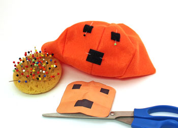 Easy Felt Crafts Emoti-Pumpkin step 6 pin loop tape to pumpkin
