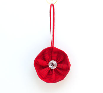 Fabric Flower Ornament red finished on display