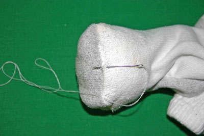 Frugal-Fun-Crafts-Mending-Socks-with-light-bulbs-white-sock-needle-and-knot