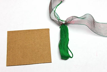 Ribbon and Bell Tassel Ornament step 11 slide yarn off card