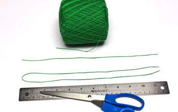 Ribbon and Bell Tassel Ornament step 3 cut yarn