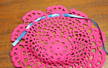 Crocheted Doily Wrapped Ornament step 2 begin weaving ribbon