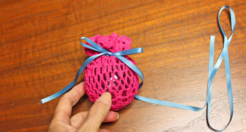 Crocheted Doily Wrapped Ornament step 5 tie ribbon bow