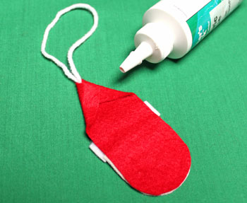 Easy Felt Santa Claus Ornament step 7 fold and glue corners for to form hat shape