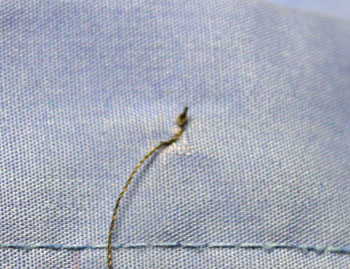How to sew on a button step 6 beginning stitches under button
