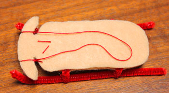 Sled Ornament step 12 add yarn to sled