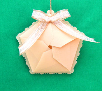Star Box Ornament gold vellum with gold ribbon hanging on display