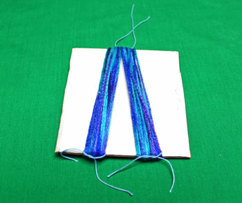Yarn Elf Ornament step 5 cut small yarn and wrap large yarn bundles