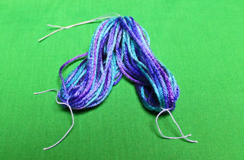 Yarn Elf Ornament step 6 pull yarn off card and tie small yarn around bundles