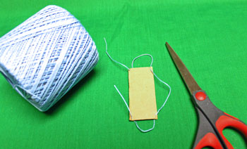 Yarn Elf Ornament step 8 wrap small yarn around perimeter of small stiff card